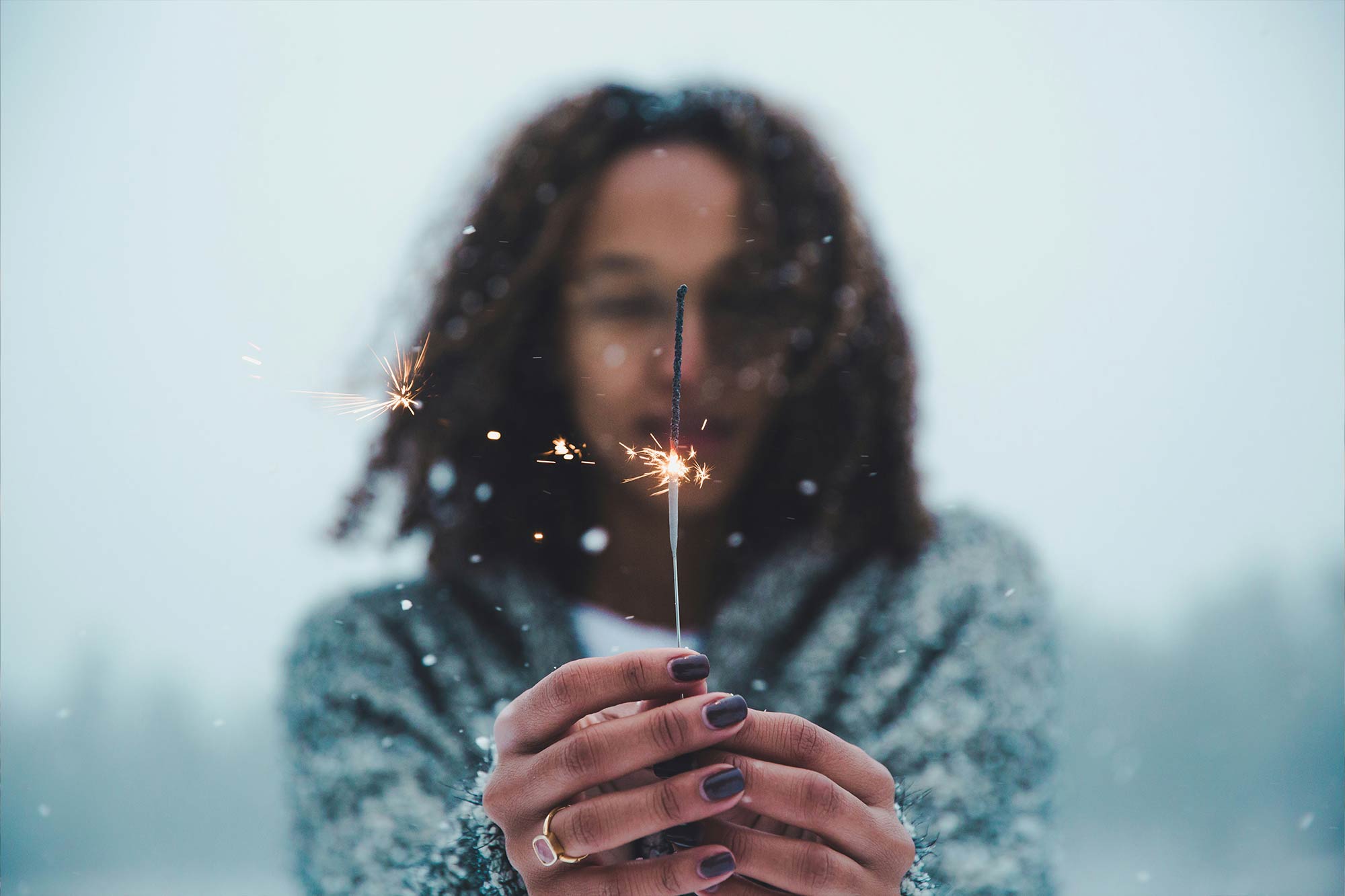 women holding a lit sparkler symbolizing inspiration and transformation. Free online webinar unleash your true potential.