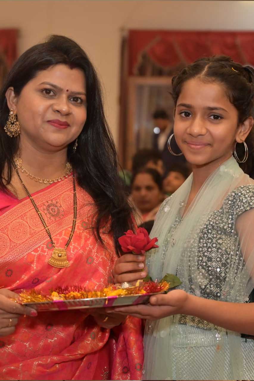  woman in her mid-40s, dressed in traditional attire, with her teenage daughter, symbolizing positive mindset and empowerment 
