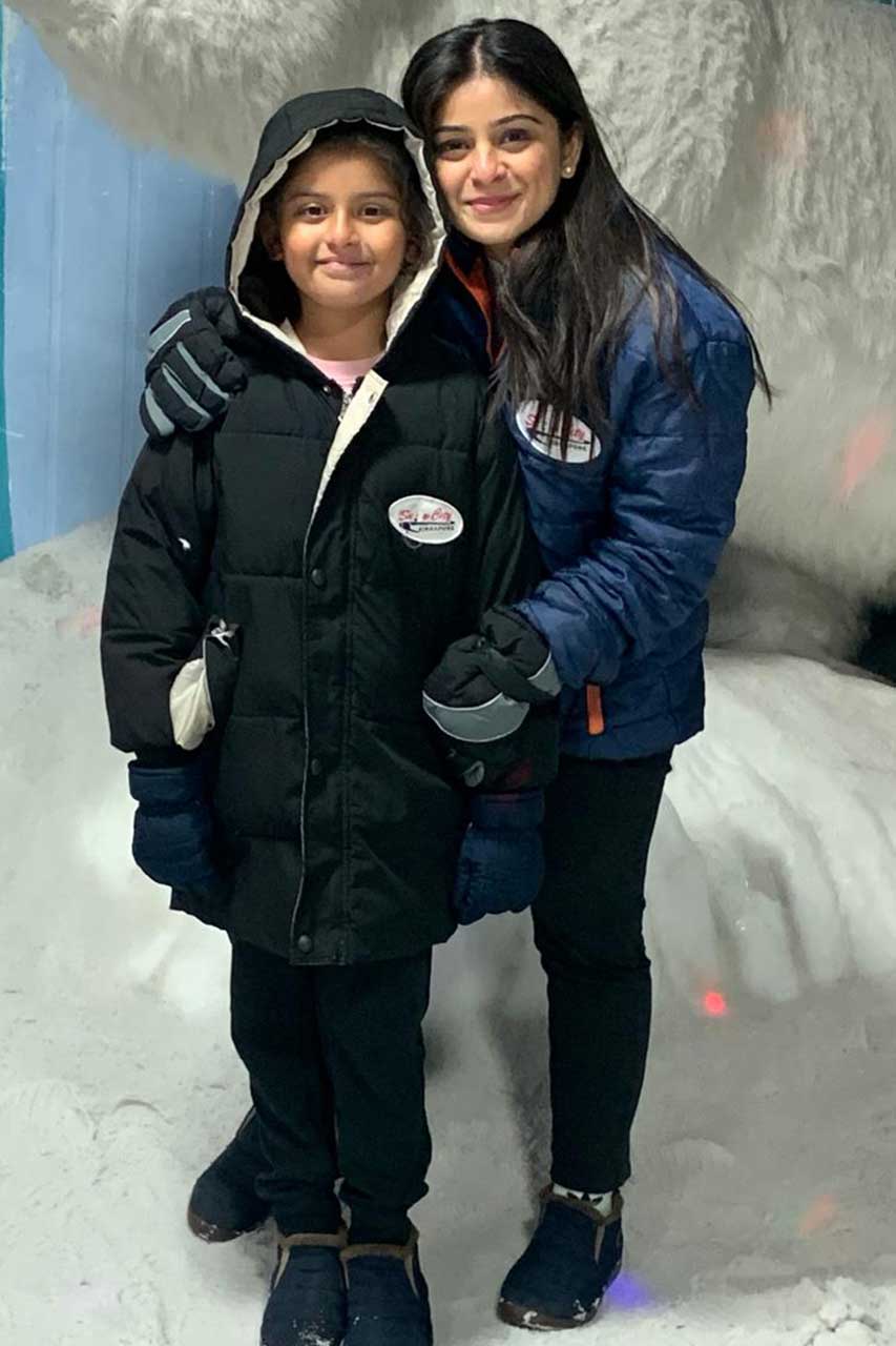  middle-aged woman joyfully playing with her daughter, symbolizing the positive impact of self-care and prioritizing well-being.