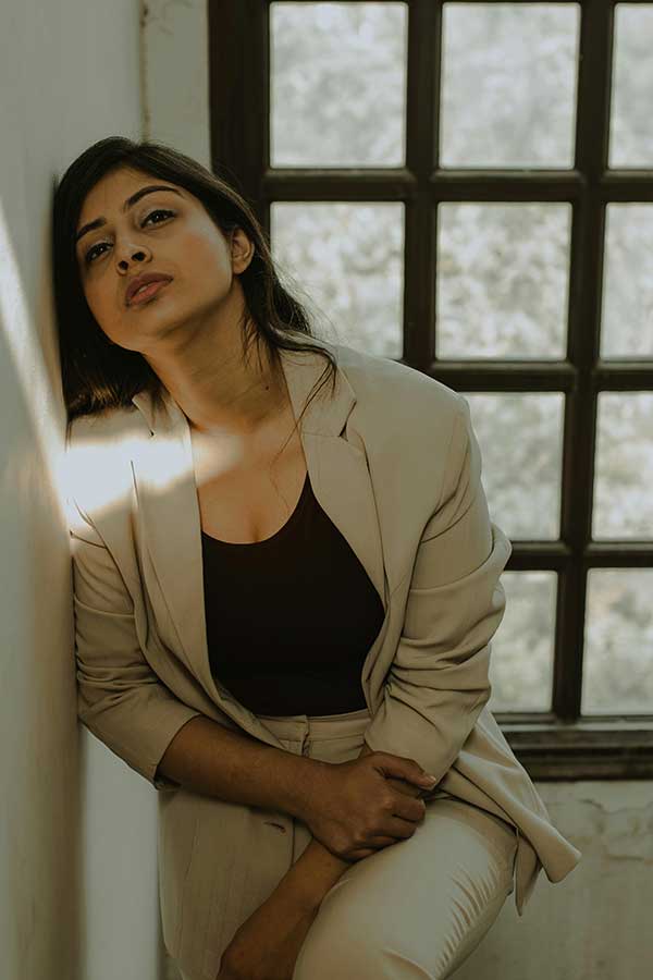  A modern young woman feeling stressed and overwhelmed, struggling to balance work and family life. 